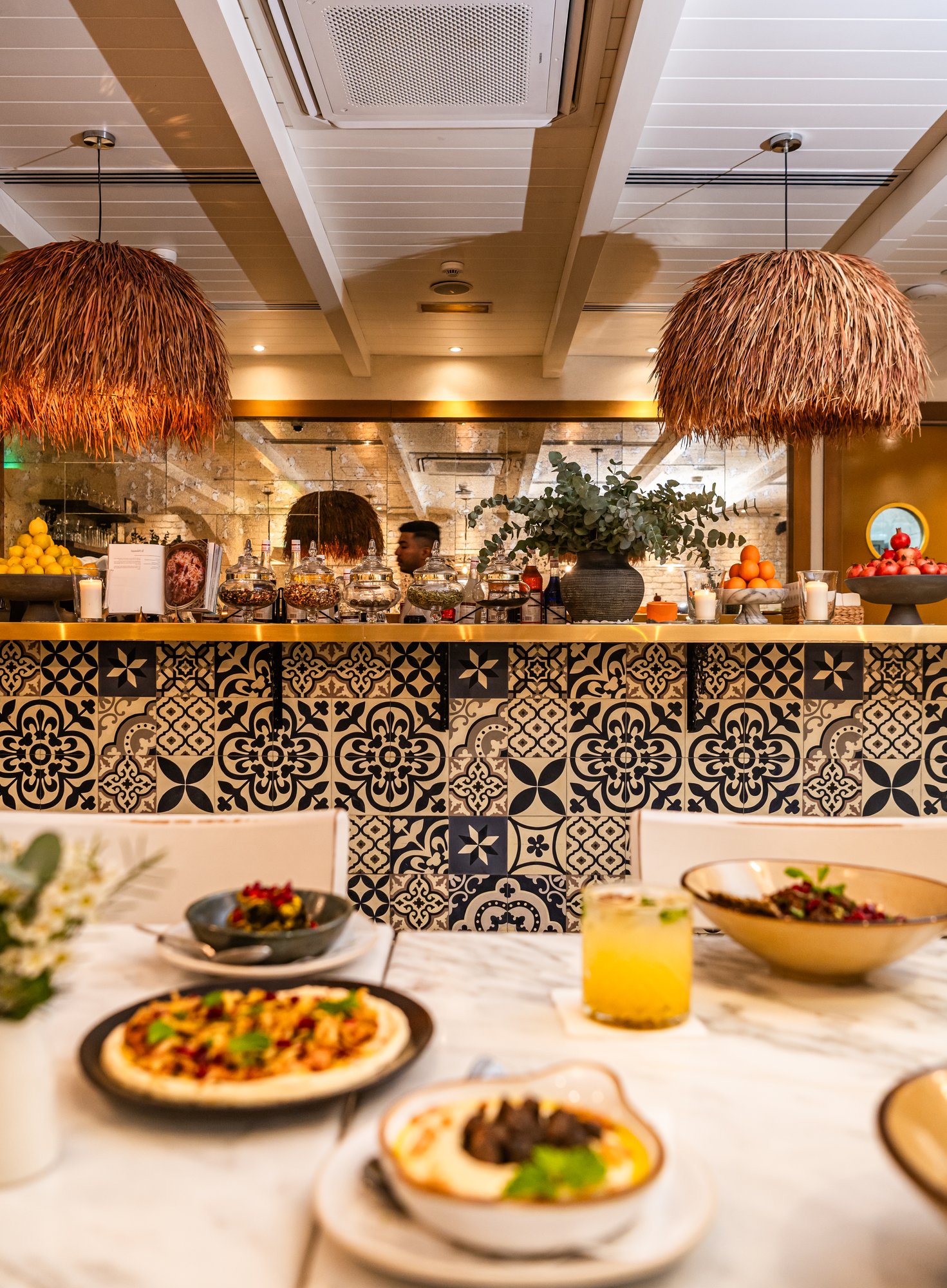 Villa Mamas Abu Dhabi patterned tiled bar with raffia pendant lamps