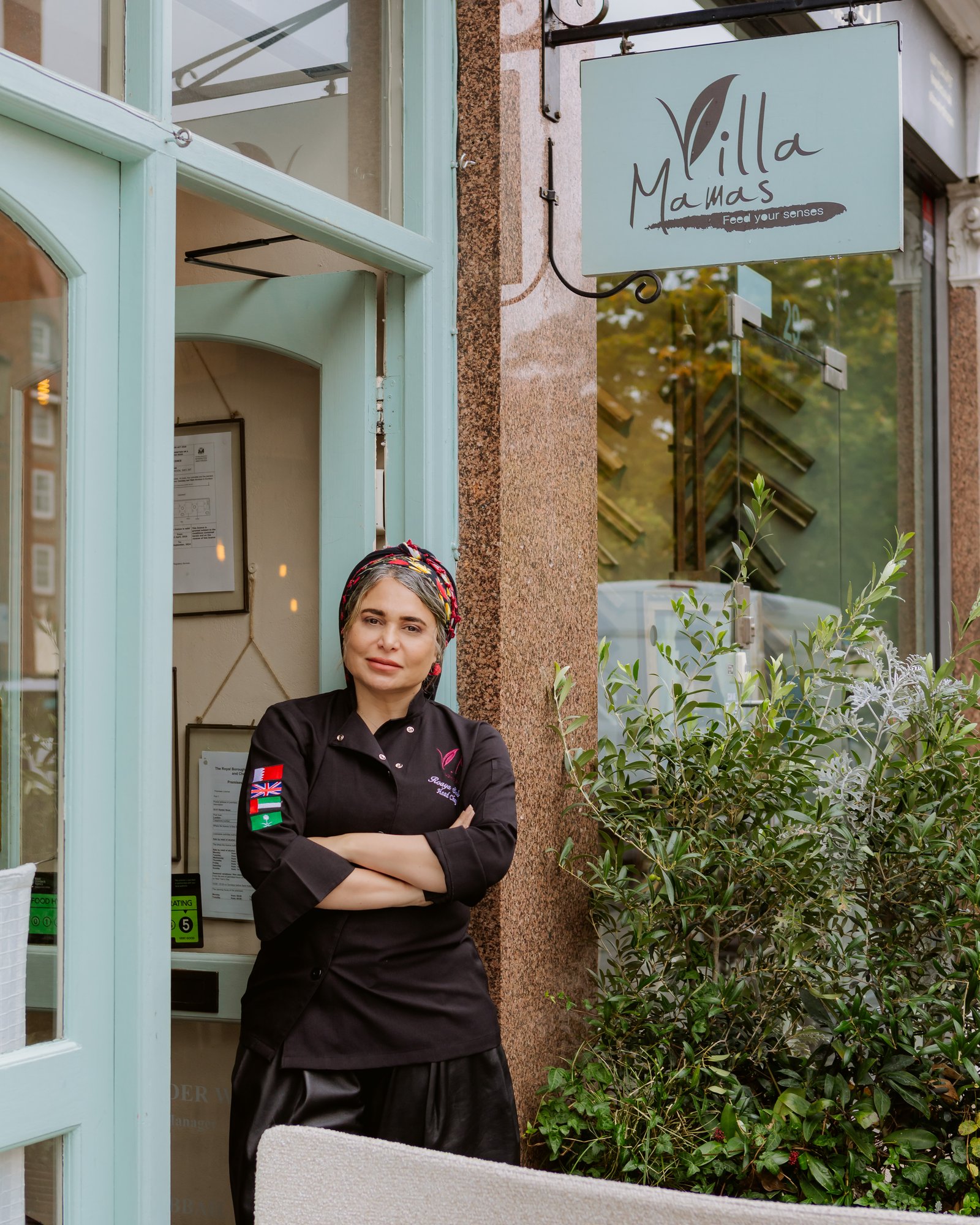 Chef Roaya Saleh at the entrance of Villa Mamas London