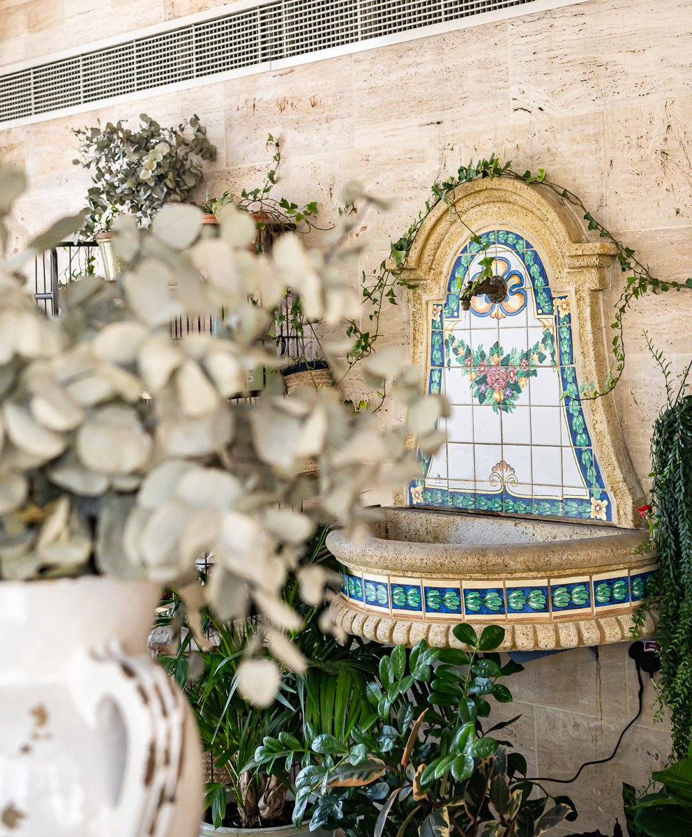 Villa Mamas Abu Dhabi hand-painted tile wall fountain framed by greenery