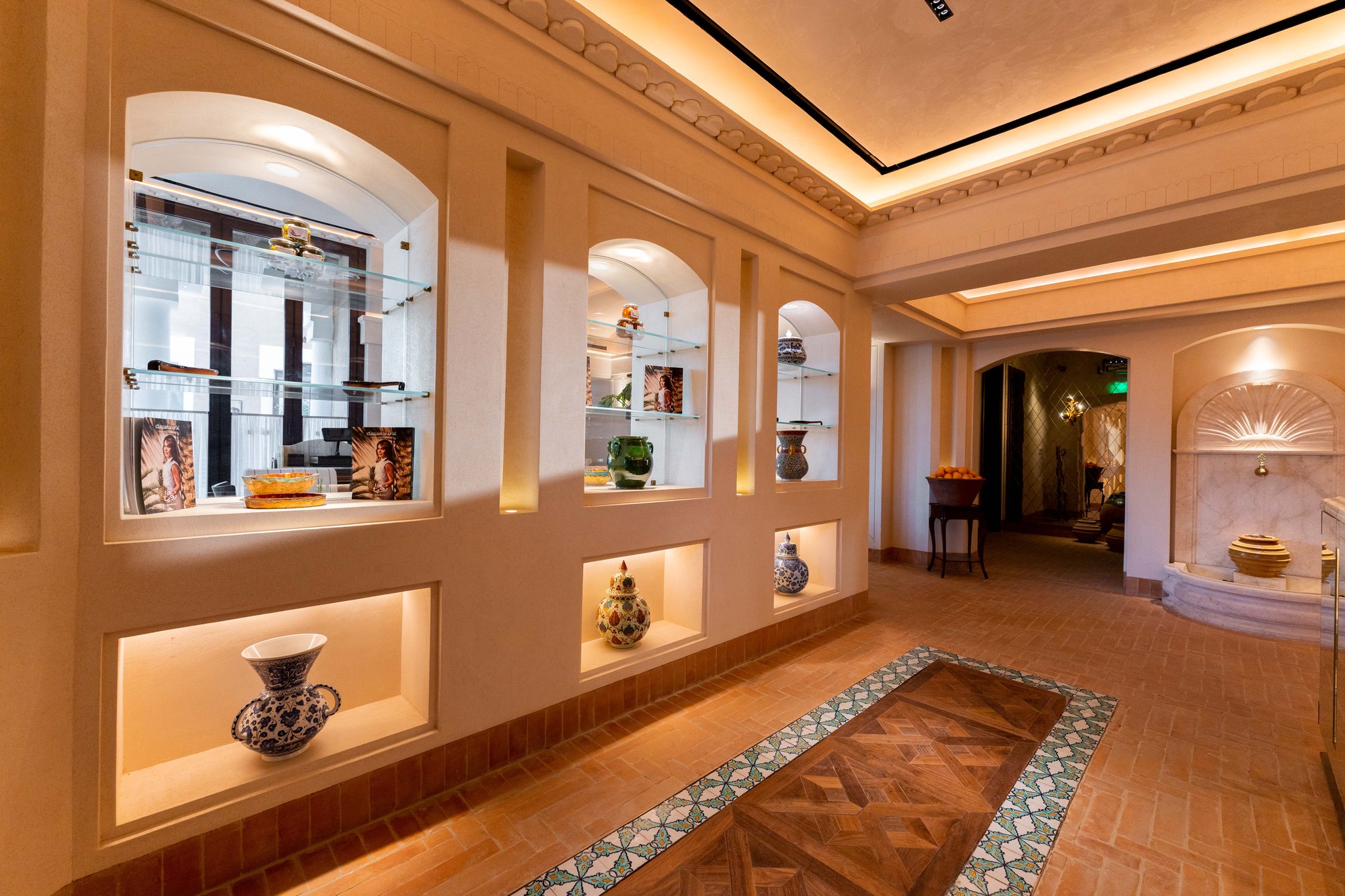 Villa Mamas Riyadh corridor with lit display niches and ceramics