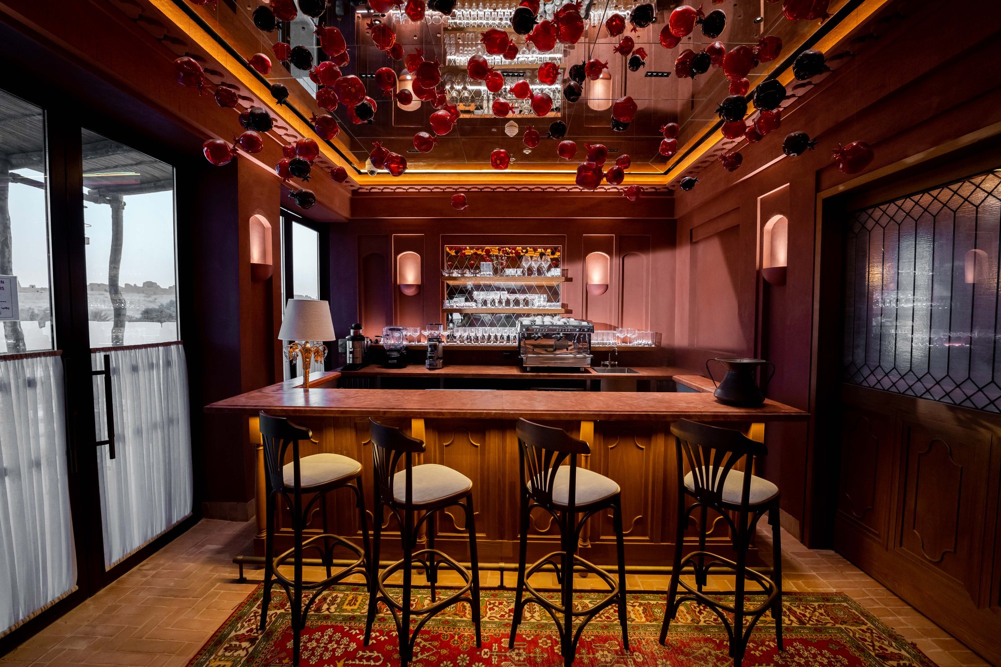 Villa Mamas Riyadh bar with hanging glass pomegranate ceiling installation