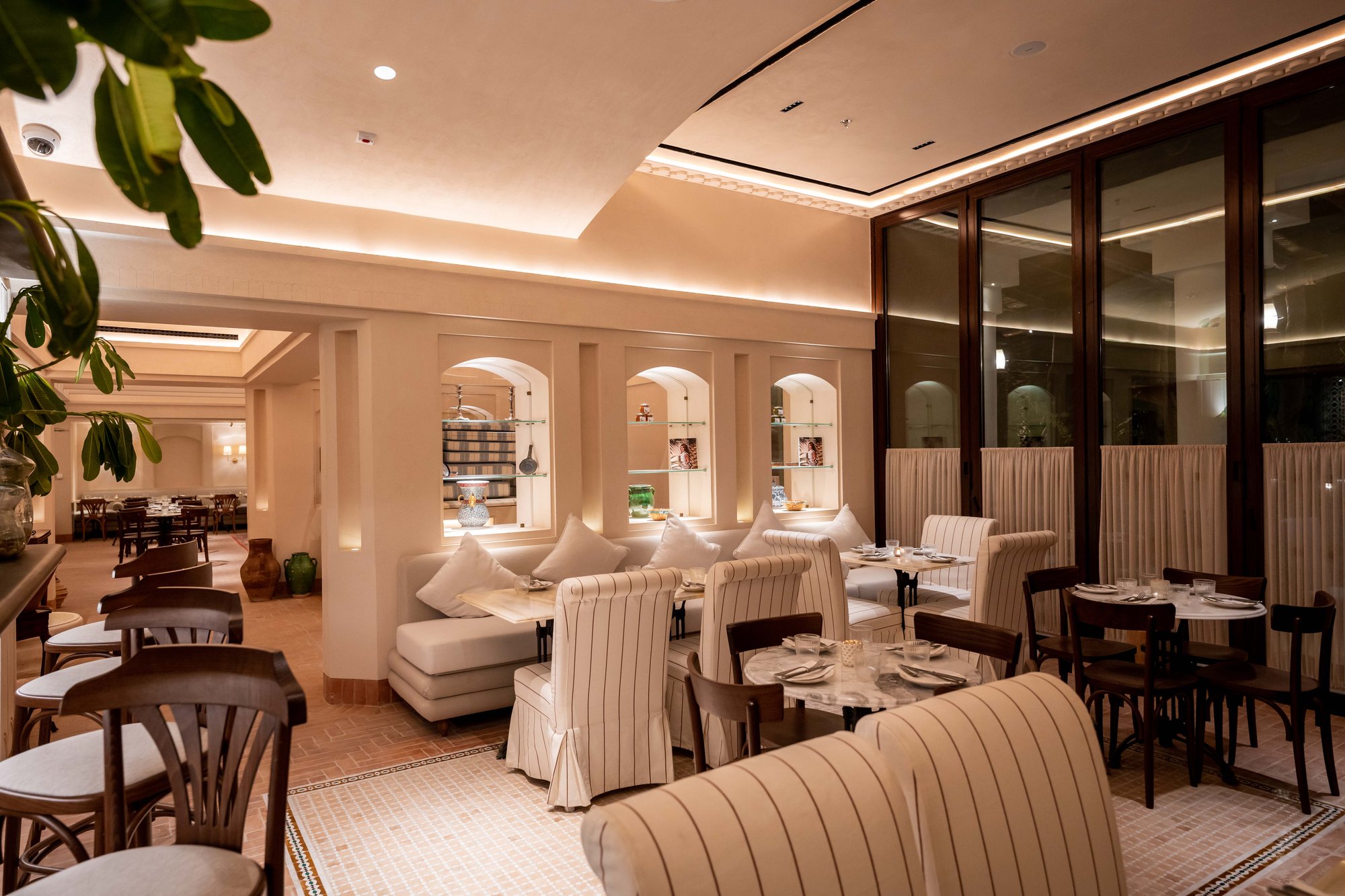 Villa Mamas Riyadh lounge with striped banquettes and arched niches