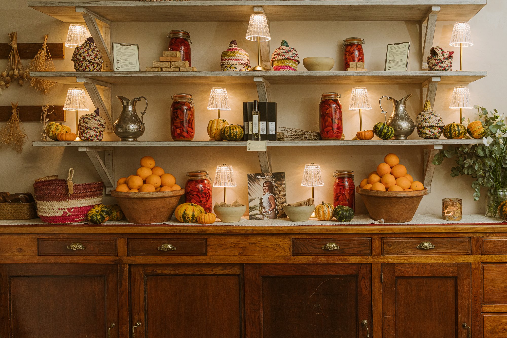 Villa Mamas London pantry shelves with preserves and lamps
