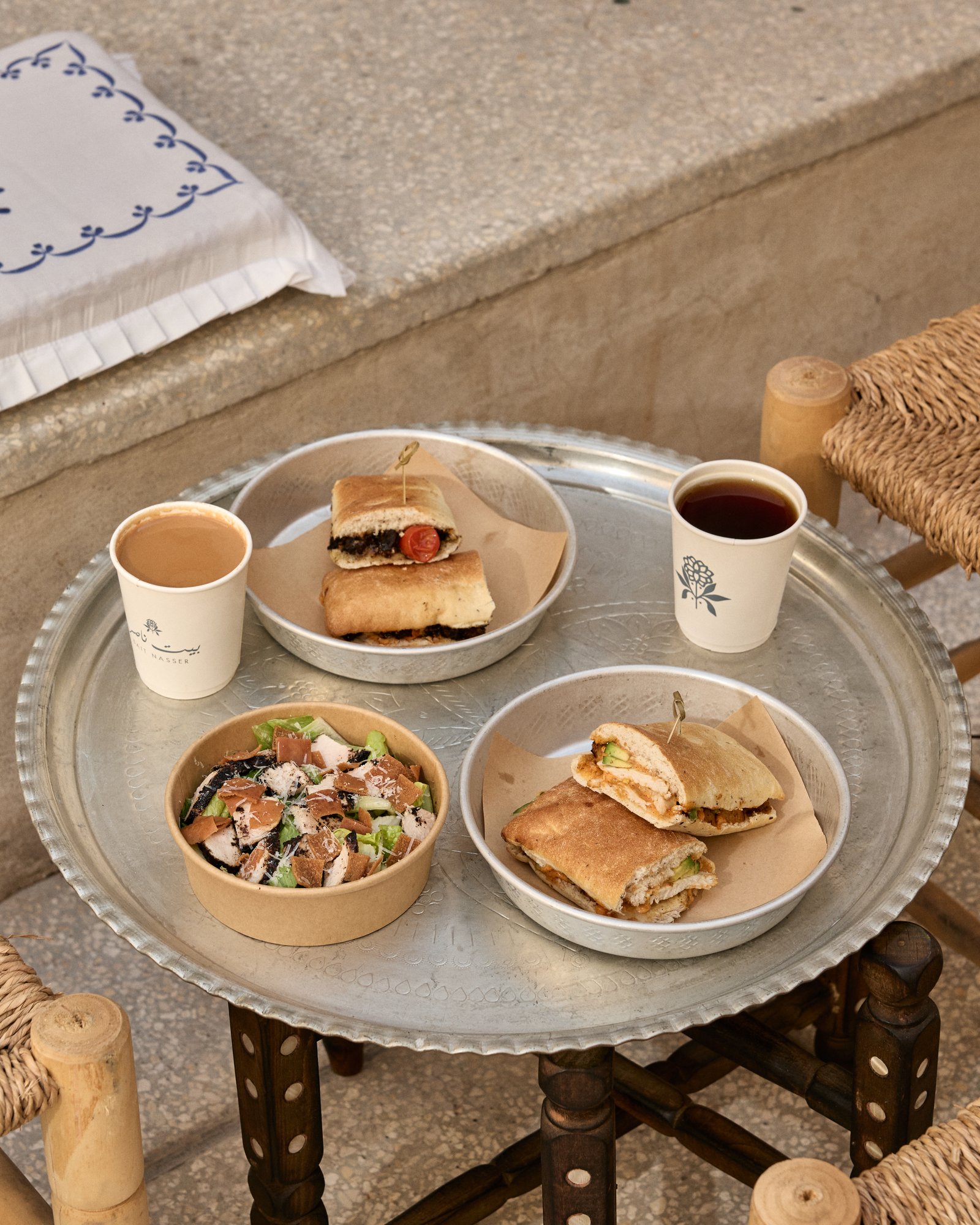 Bait Nasser breakfast tray with sandwiches, salad and coffee on a silver tray